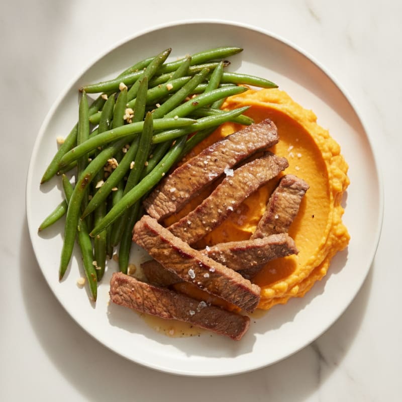 Seared Lean Beef Strips with Garlic Green Beans and Sweet Potato Mash