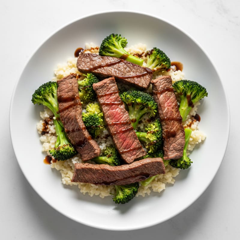 Seared Lean Beef Strips with Steamed Broccoli and Cauliflower Rice