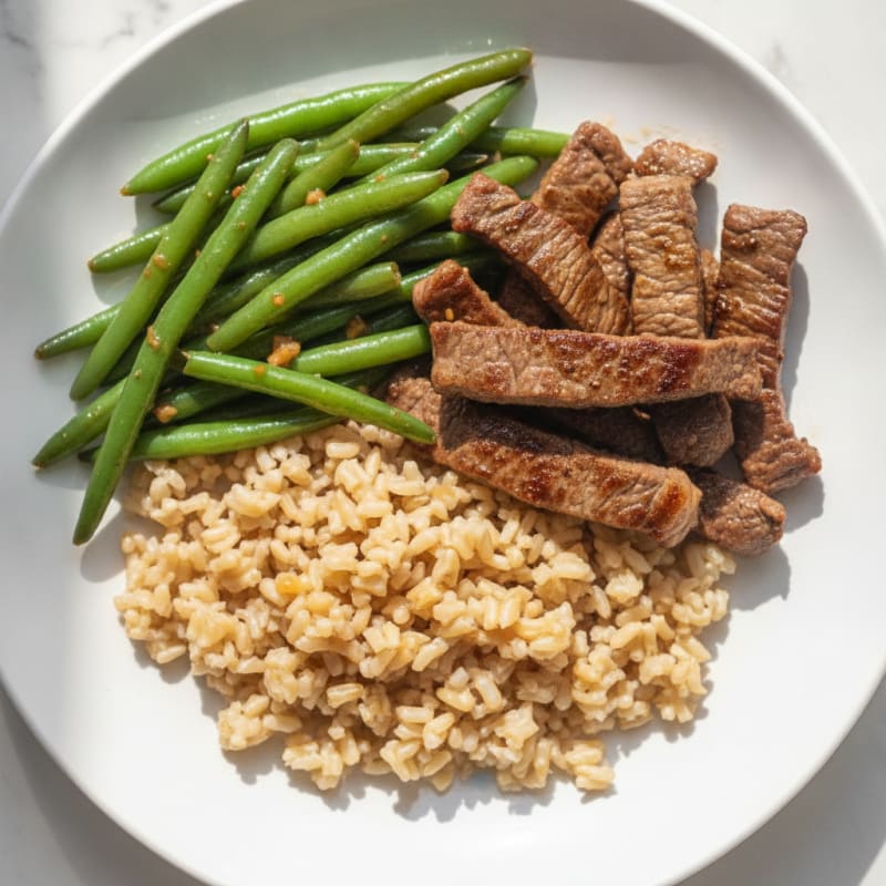 Seared Beef Strips with Garlic Green Beans and Brown Rice