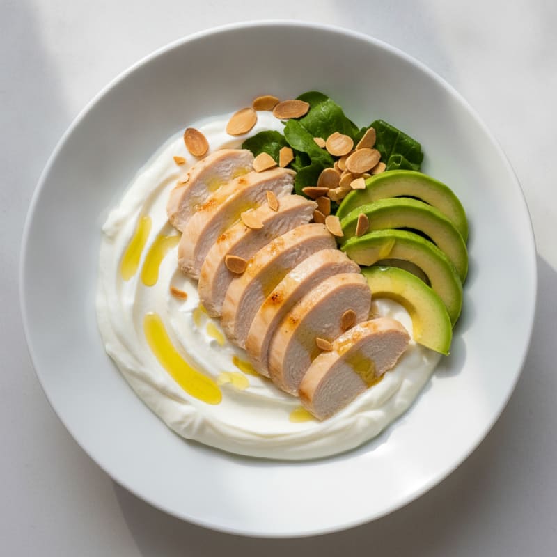 Creamy Greek Yogurt Bowl with Sliced Chicken Breast and Almonds