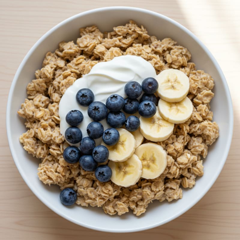 Greek Yogurt Oatmeal Bowl with Berries and Sliced Bananas