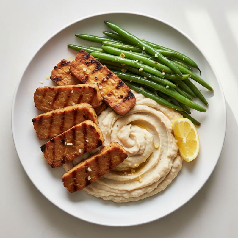 Grilled Tempeh with Creamy White Bean Mash and Garlic Green Beans
