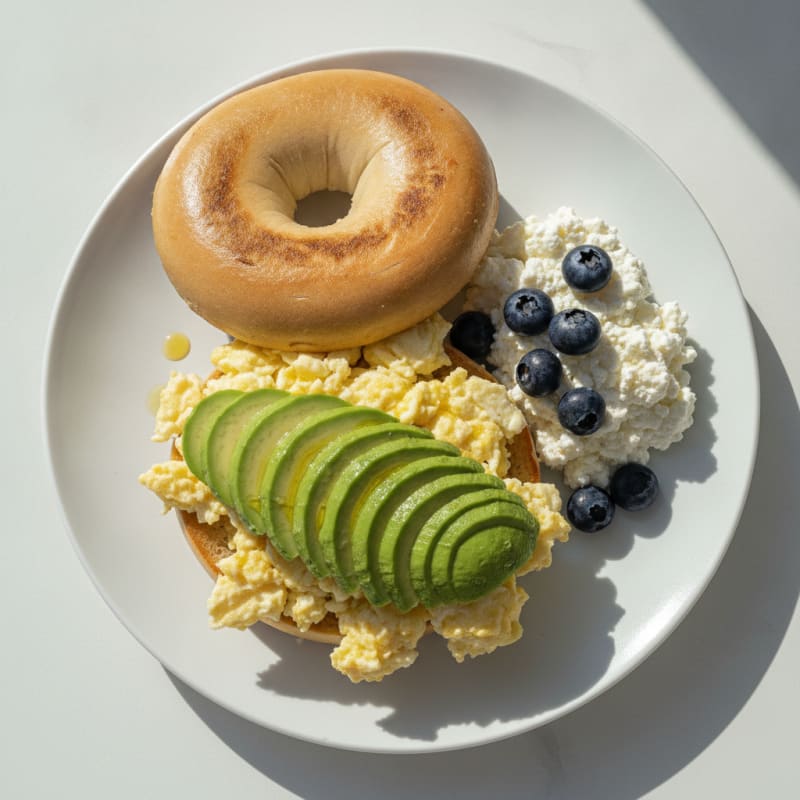 Egg White and Avocado Bagel with Cottage Cheese and Blueberries