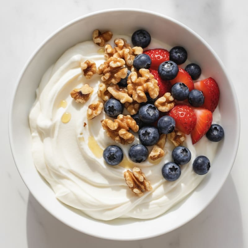 Silky Protein Yogurt with Chopped Walnuts and Fresh Berries
