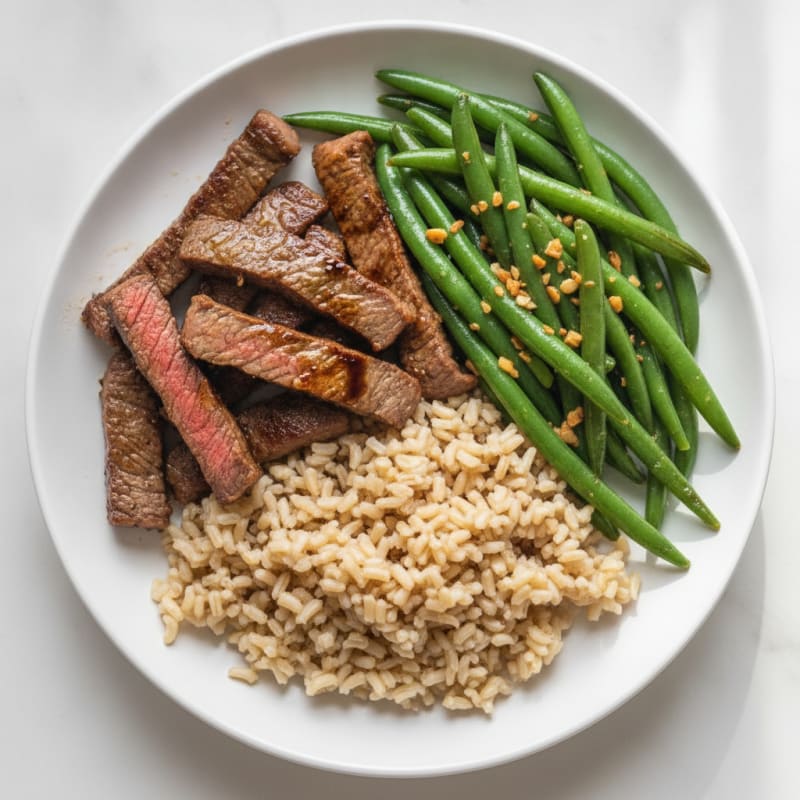Seared Lean Beef Strips with Steamed Green Beans and Brown Rice