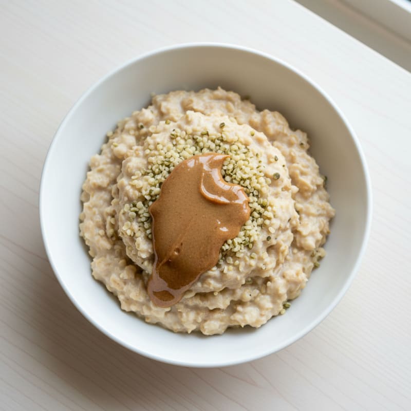 Silky Vanilla Protein Oats with Almond Butter and Hemp Seeds