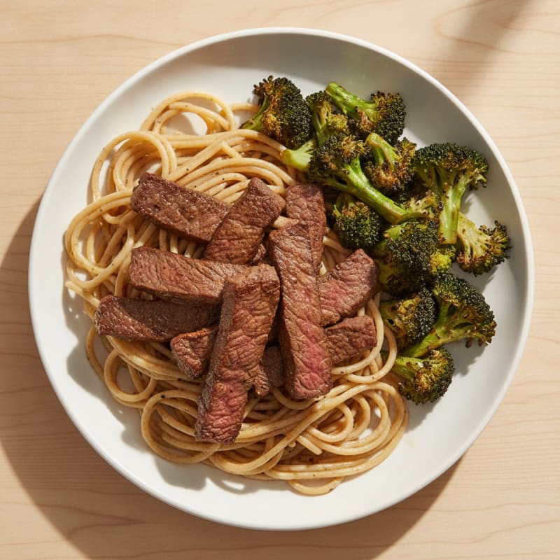 Seared Steak Strips with Roasted Broccoli and Garlic Noodles