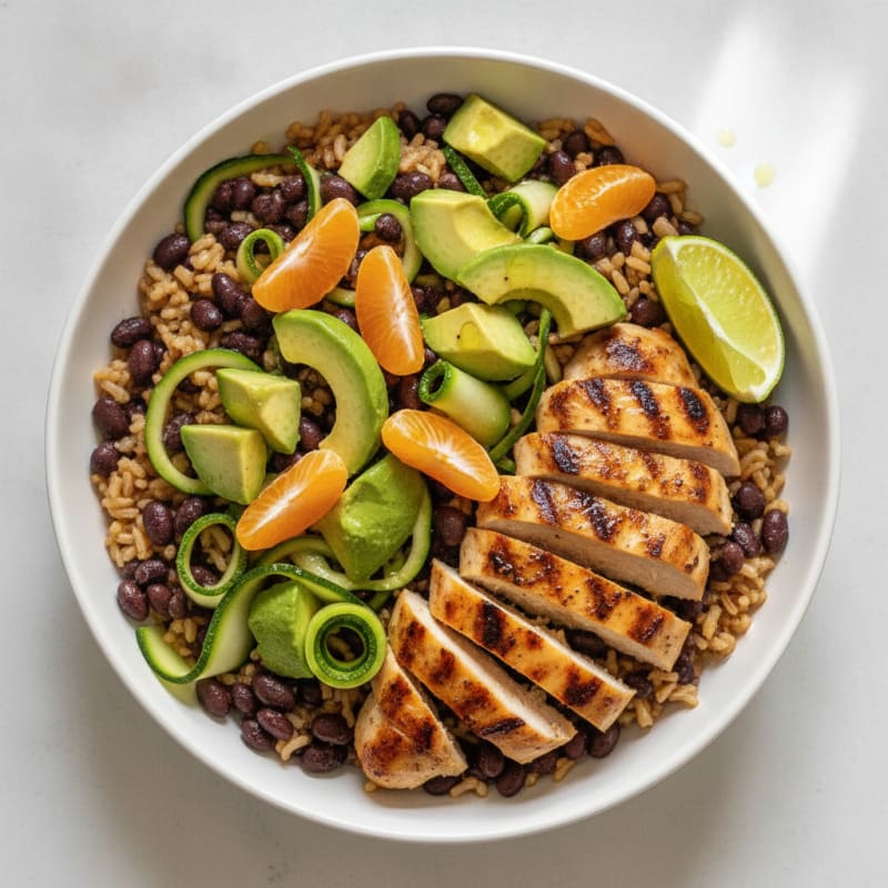 Grilled Chicken and Avocado Rice Bowl with Black Beans and Clementine Slices