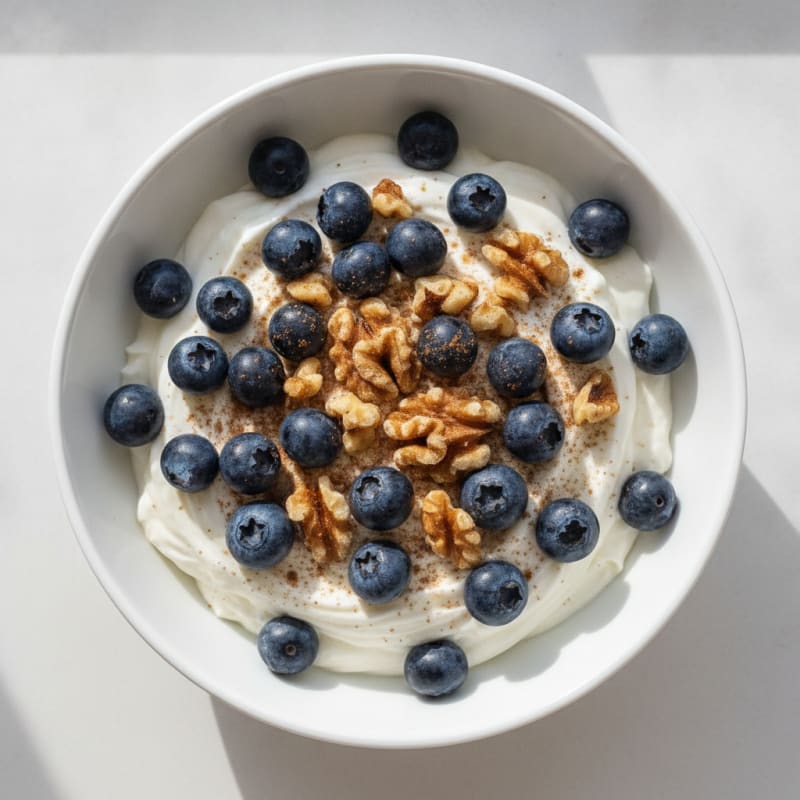 High-Protein Greek Yogurt Bowl with Chopped Nuts and Berries