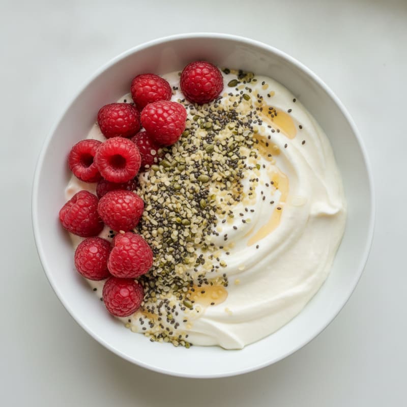 Silky Protein Yogurt Bowl with Mixed Seeds and Raspberries