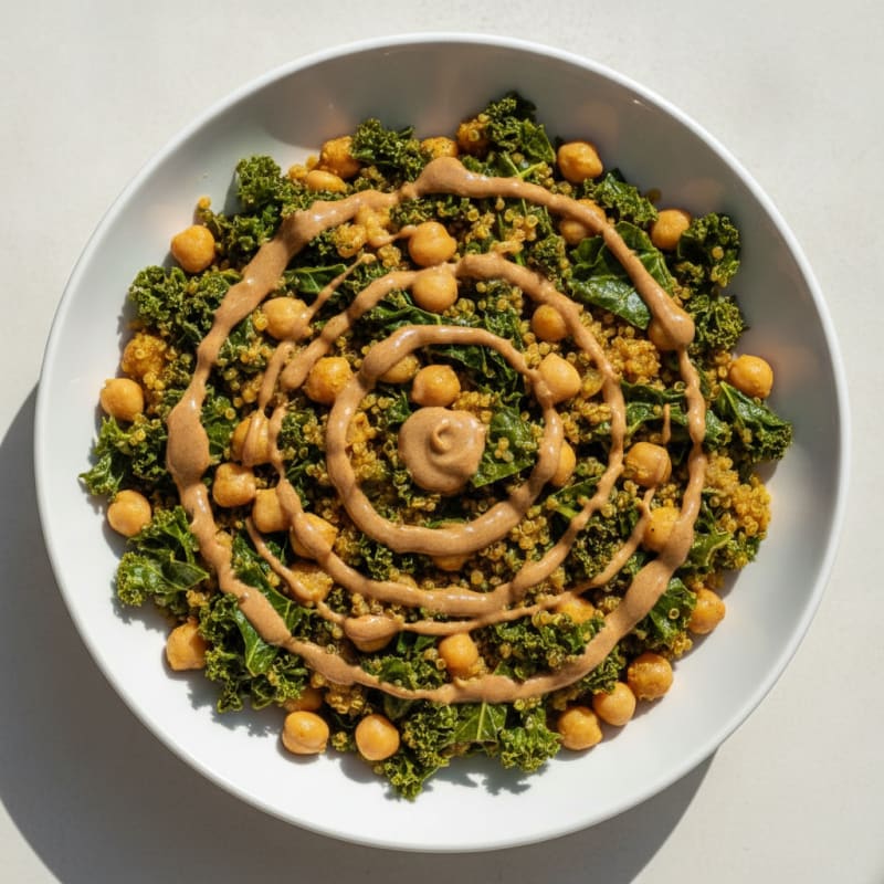 Silky Chickpea Quinoa Breakfast Bowl with Kale and Almond Butter Drizzle