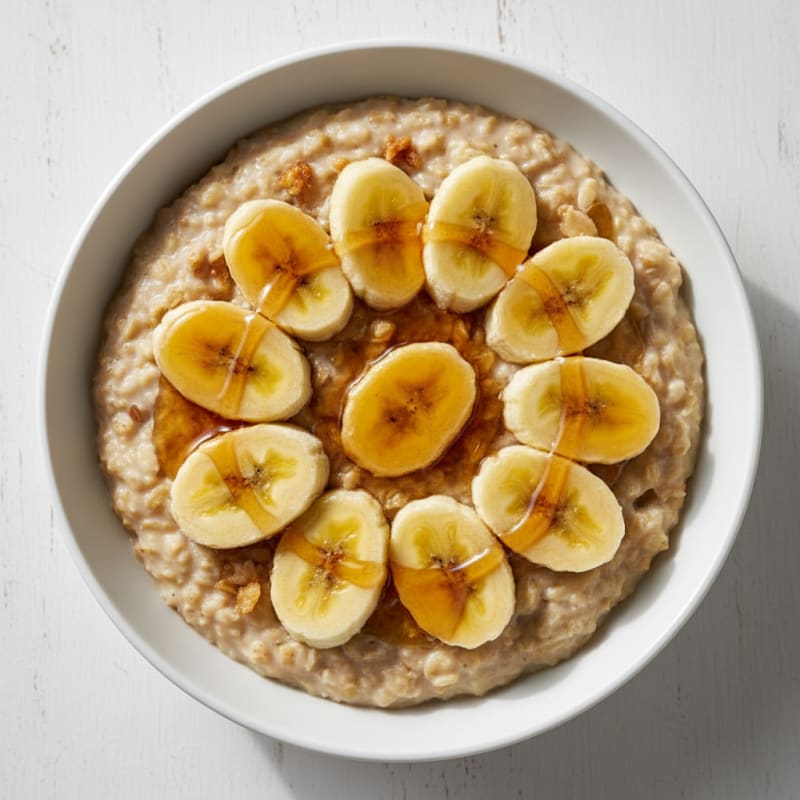 Creamy Oatmeal with Sliced Banana and Maple Drizzle