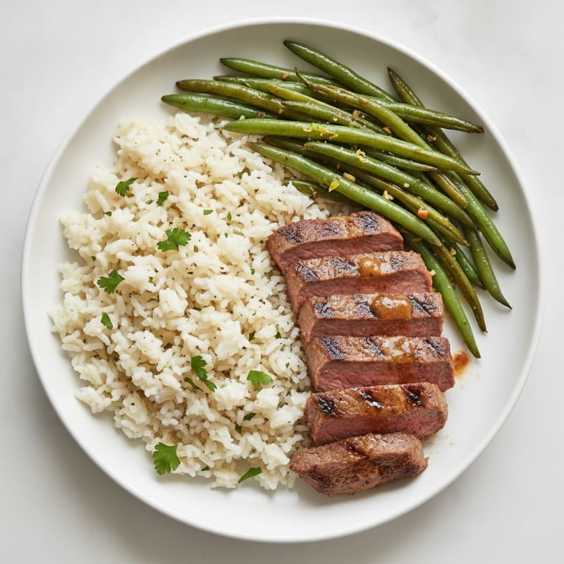 Seared Beef Strips with Garlic Herb Rice and Sautéed Green Beans