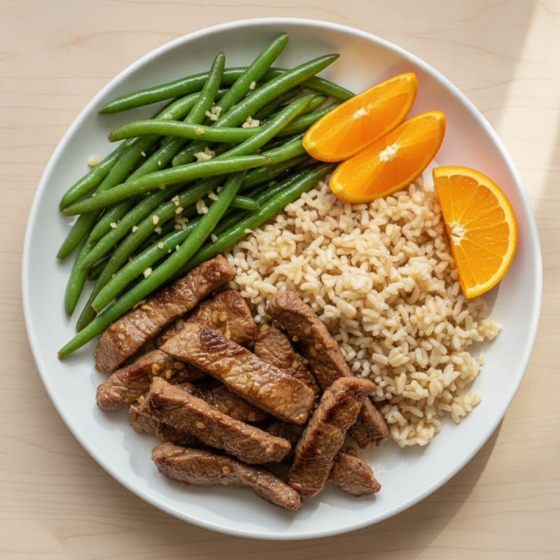 Seared Lean Beef Strips with Steamed Rice and Sautéed Green Beans