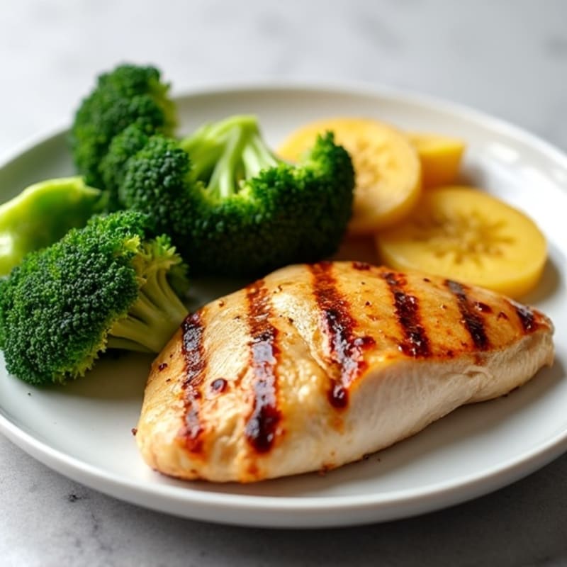Grilled Chicken Breast with Steamed Broccoli and Sautéed Plantains