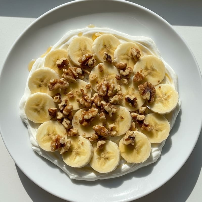 Protein Greek Yogurt Parfait with Sliced Banana and Chopped Walnuts
