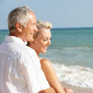 senior couple enjoying beach holiday