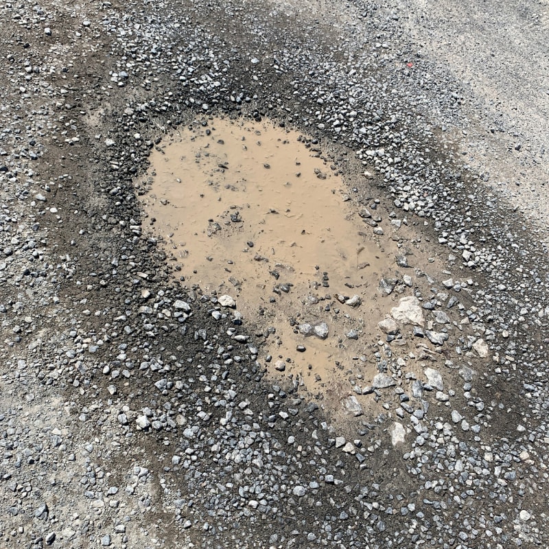 fix potholes in gravel driveway