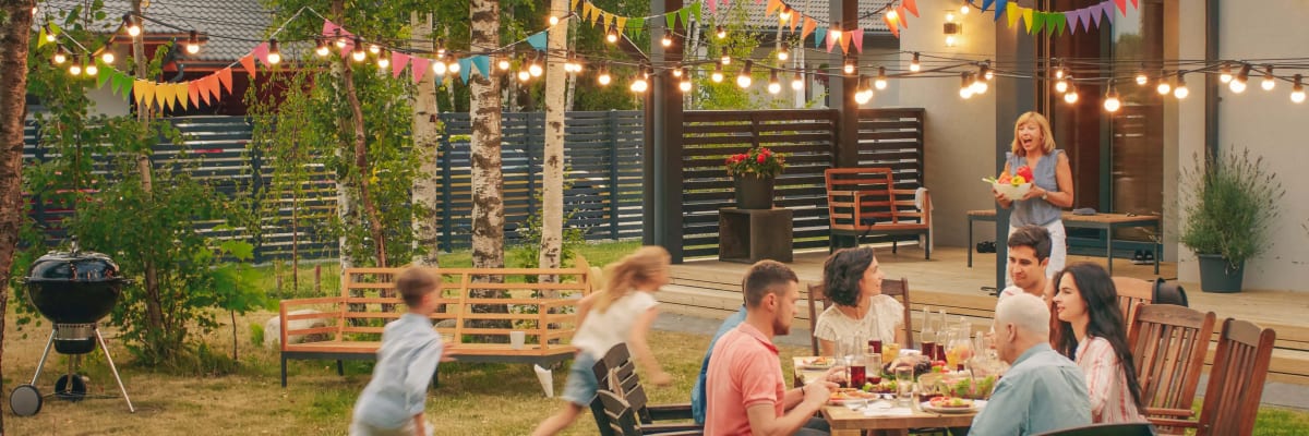 Family enjoying pest-free backyard with SpraySquad treatment