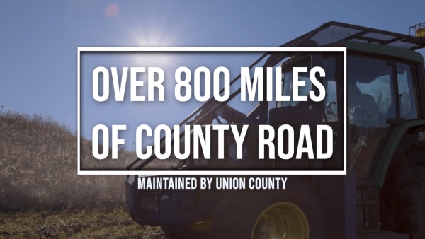 Road department heavy equipment on county road