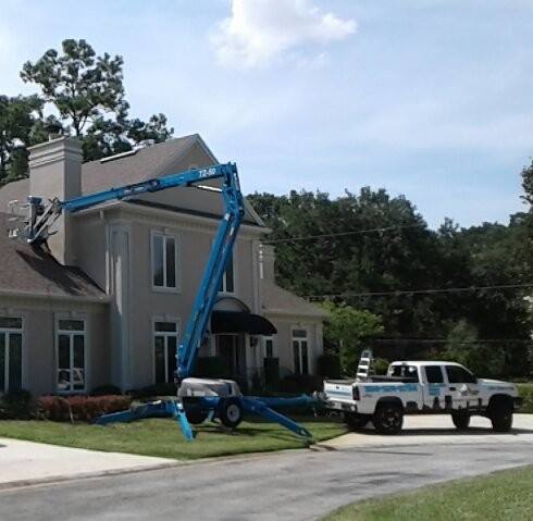 Residential property getting the exterior painted with crane