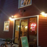 Barn Owl Brewing entrance with a bicycle and Open sign