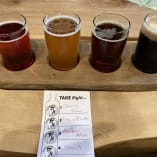 Beer flight from Barn Owl Brewing with a Cherry Sour, Passionfruit, Amber Ale and Stout beer