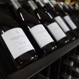 A row of CedarCreek Estate Winery Pinot Noir bottles on a shelf at the CedarCreek Estate Winery in Kelowna.