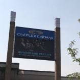 Signage for Cineplex Cinemas Orchard Plaza in Kelowna, advertising luxury reclining seats with the text Unwind and Recline.