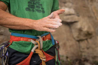 A rock climber dusts his hands with chalk at Skaha Bluffs Provincial Park near Penticton.