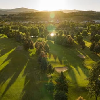 an aerial view of a golf course with the sun shining through the trees and a golf course in the foreground, Shadow Ridge Golf Club, Kelowna