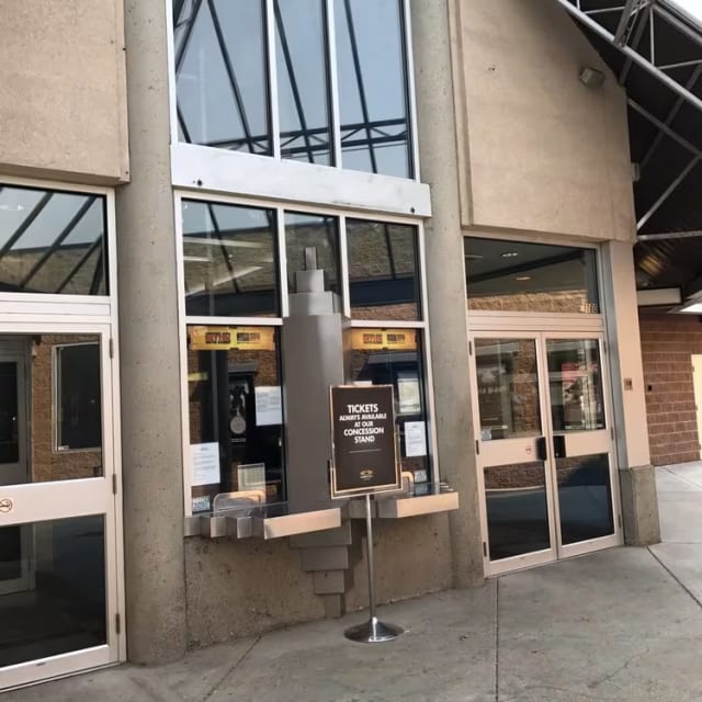 Entrance of Cineplex Cinemas Orchard Plaza in Kelowna with ticket counters and a sign directing to the concession stand.