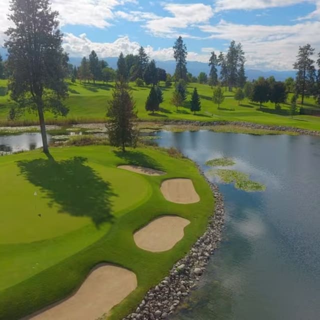 An aerial view of a golf course with a pond and a fountain, Kelowna Golf & Country Club, Kelowna.