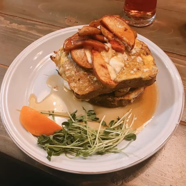 A plate of French toast topped with apple slices and served with greens, photographed at Rustic Reel Brewing Co. in Kelowna.