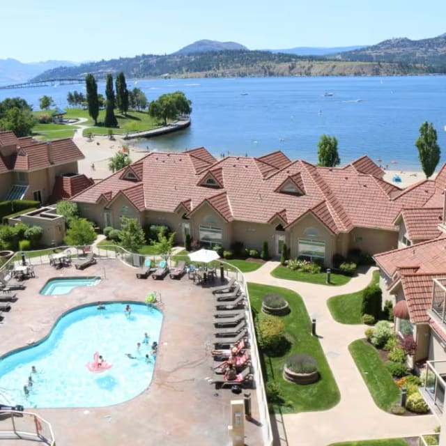 an aerial view of a resort with a pool and hot tub in the middle of the