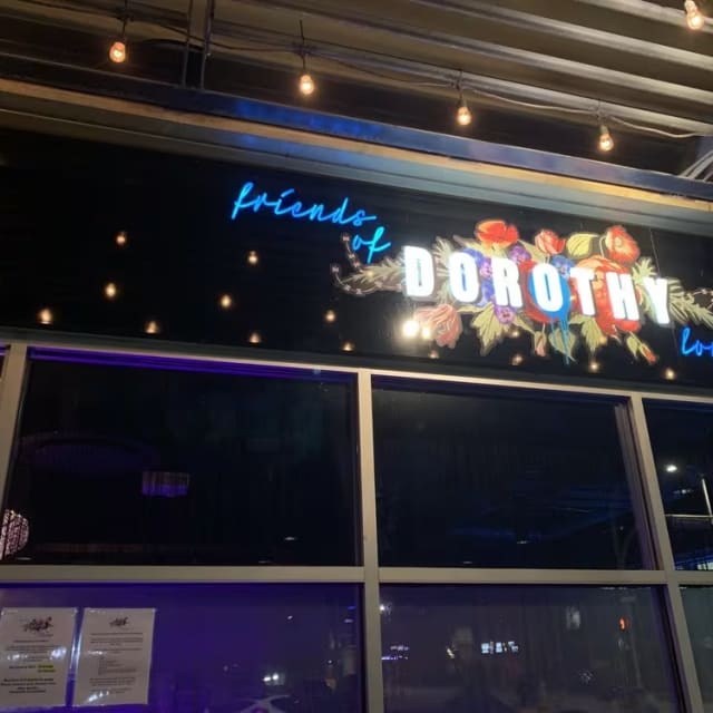 The front of a restaurant with a sign that says Friends of Dorothy Lounge on the front of the building.
