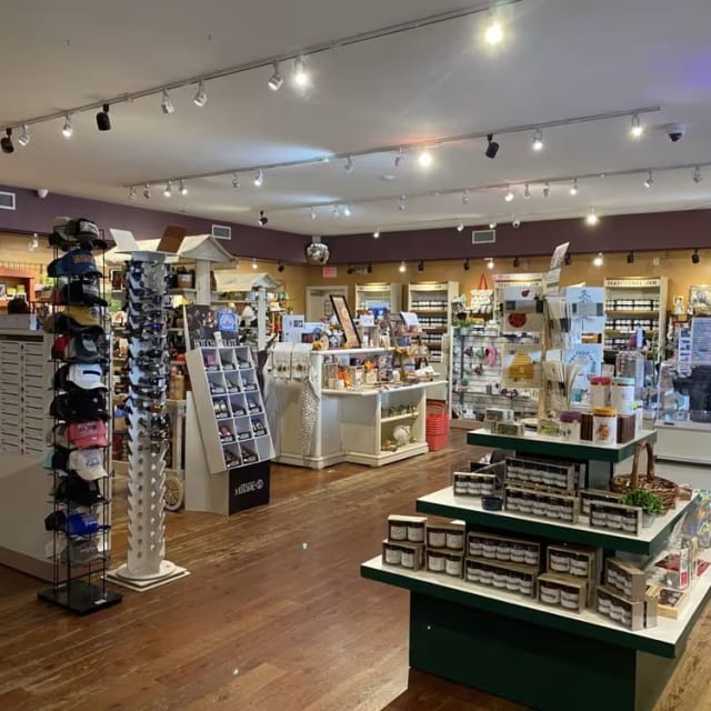 A well-lit store at The Jammery in Lake Country showcasing various products including hats, souvenirs, and jars of jam.