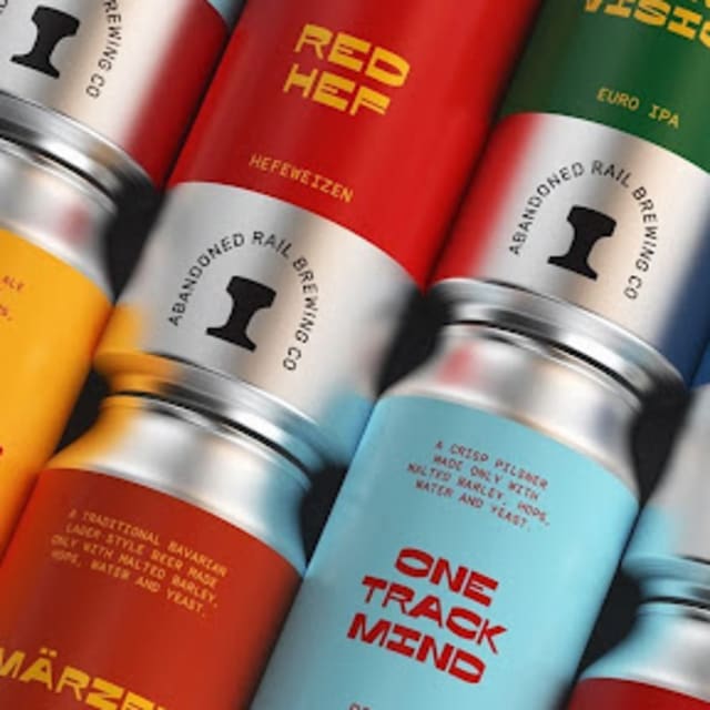 Assorted colorful beer cans from Abandoned Rail Brewing Co., including Golden Ale, Hefeweizen, Euro IPA, and more.