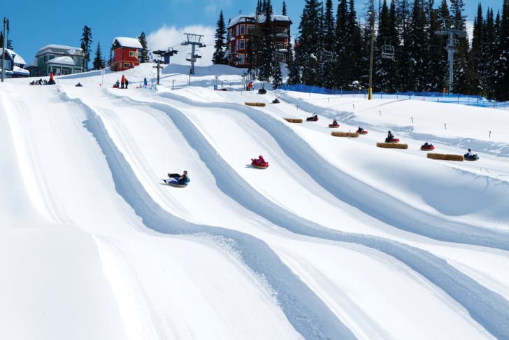 Mountain-goers sliding down the tube slide at SilverStar.