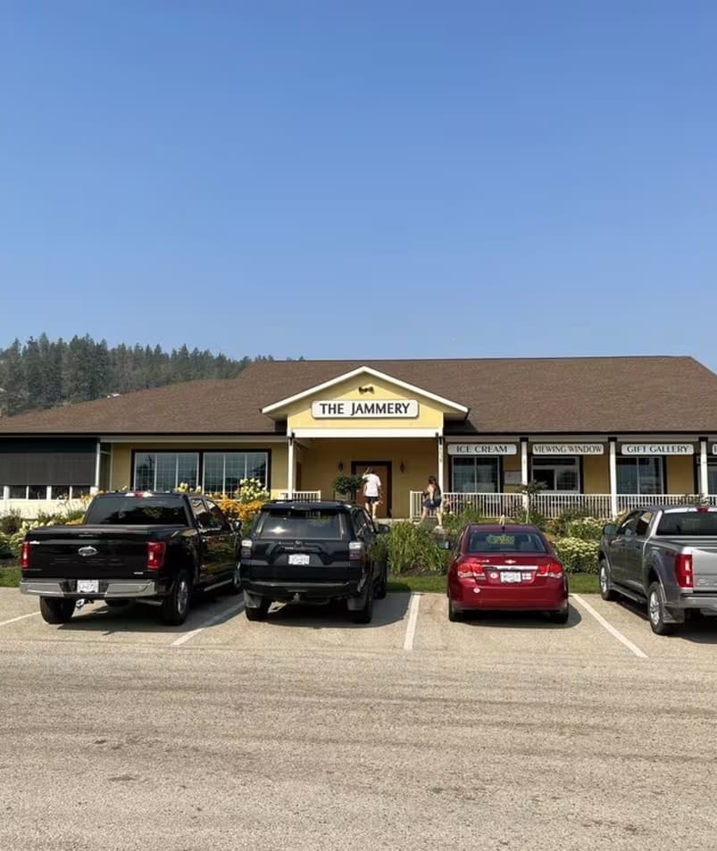 The Jammery, a yellow building in Lake Country with signs for ice cream, viewing window, gift gallery, homemade jams, and loose leaf teas, viewed from a parking lot.