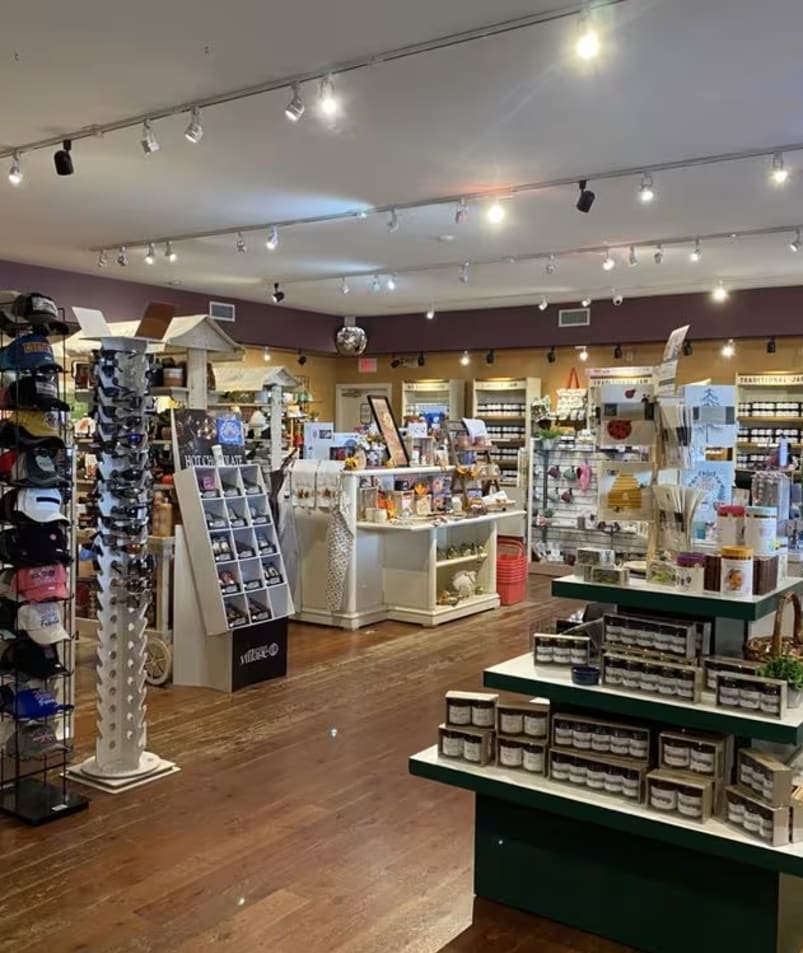 A well-lit store at The Jammery in Lake Country showcasing various products including hats, souvenirs, and jars of jam.