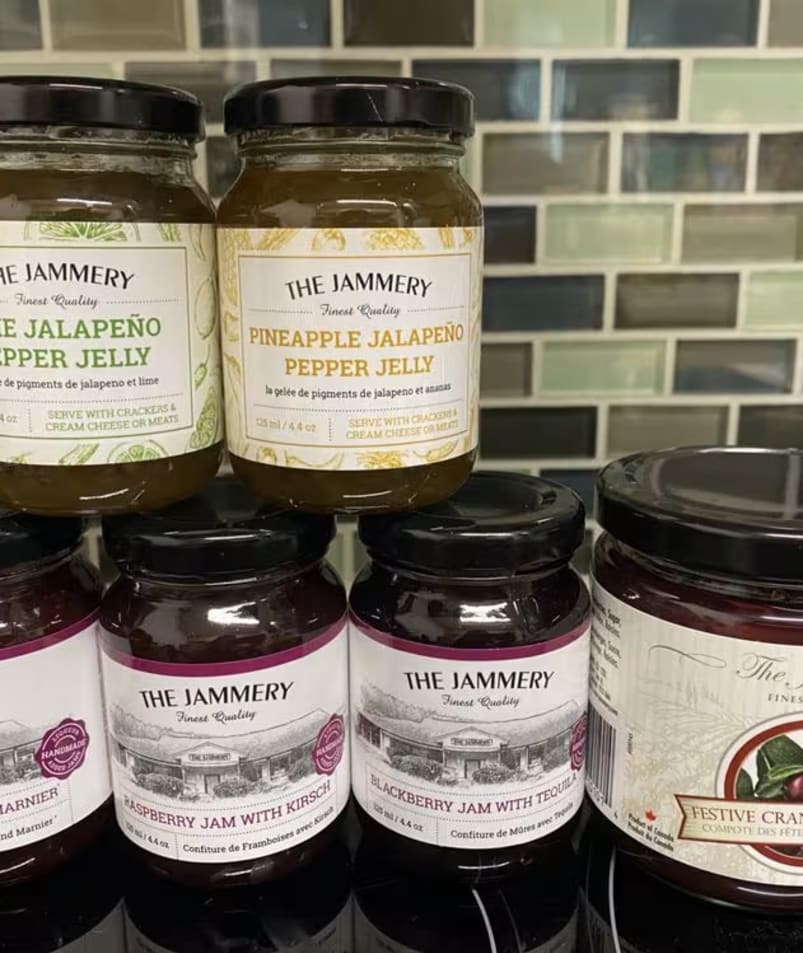 Various jars of jams and jellies from The Jammery in Lake Country displayed on a counter.
