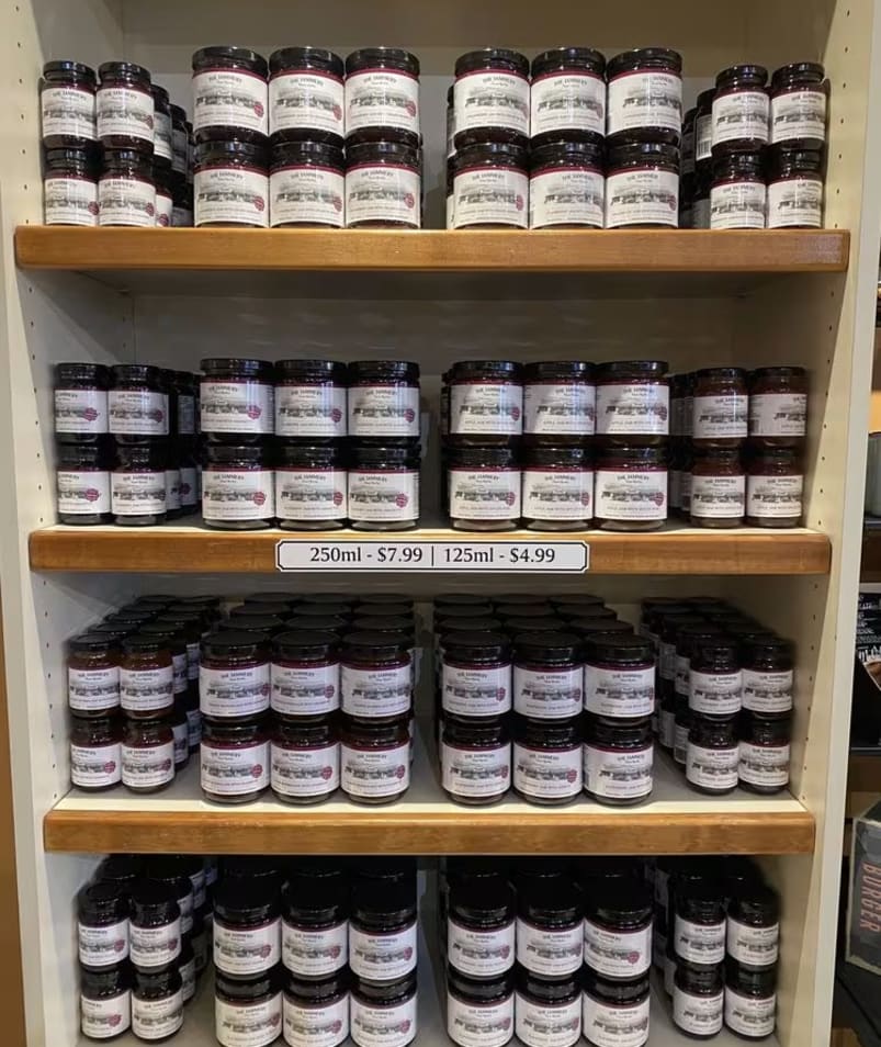 Display shelves at The Jammery in Lake Country filled with jars of jam, with price tags for 250ml at $7.99 and 125ml at $4.99.