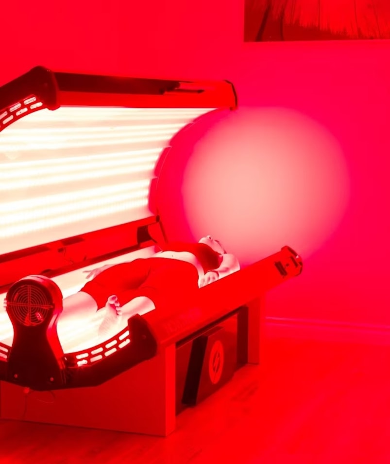 A person undergoing red light therapy in a spa bed at The Recovery Spa in Kelowna.