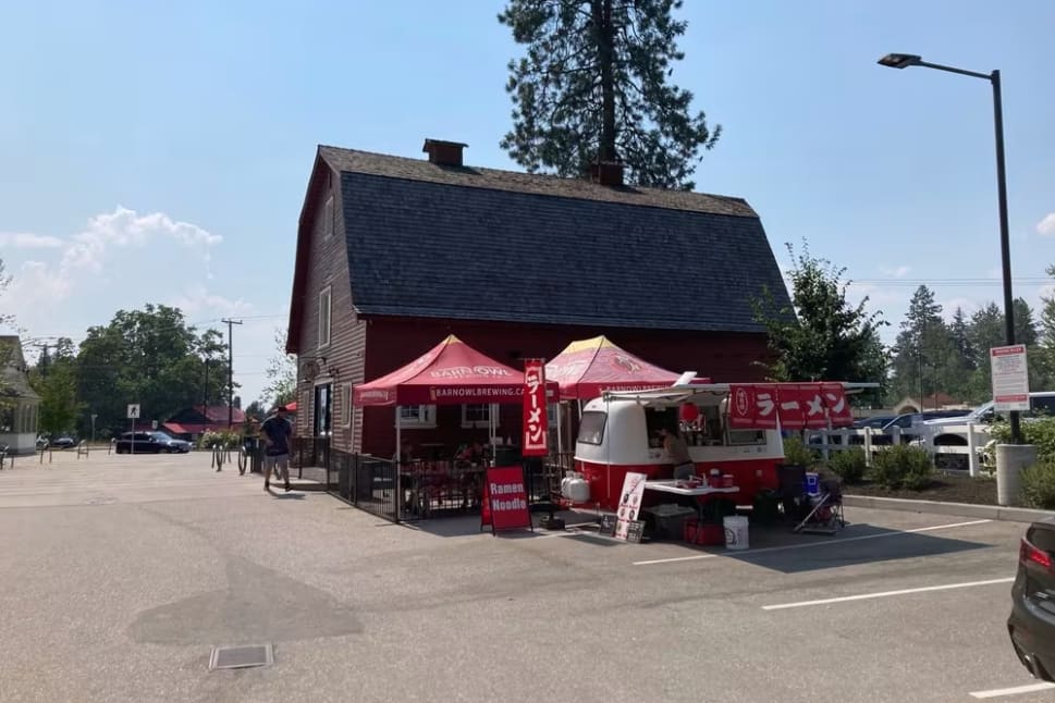 Exterior of the Barn Owl Brewing barn with a food truck next to the building