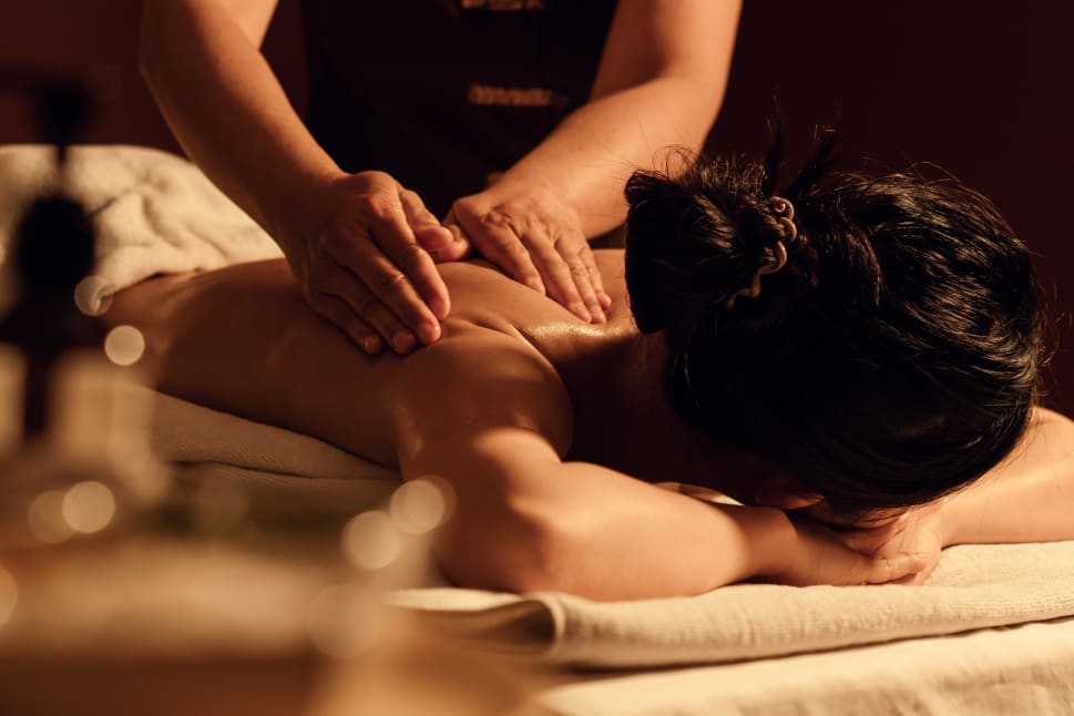 A relaxing back massage being given in a tranquil spa setting.
