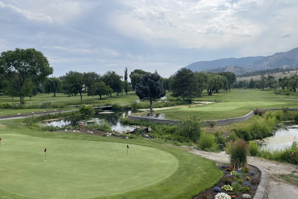 Beautiful golf course in Penticton with lush green fairways, small ponds, and mountains in the background under a partly cloudy sky.