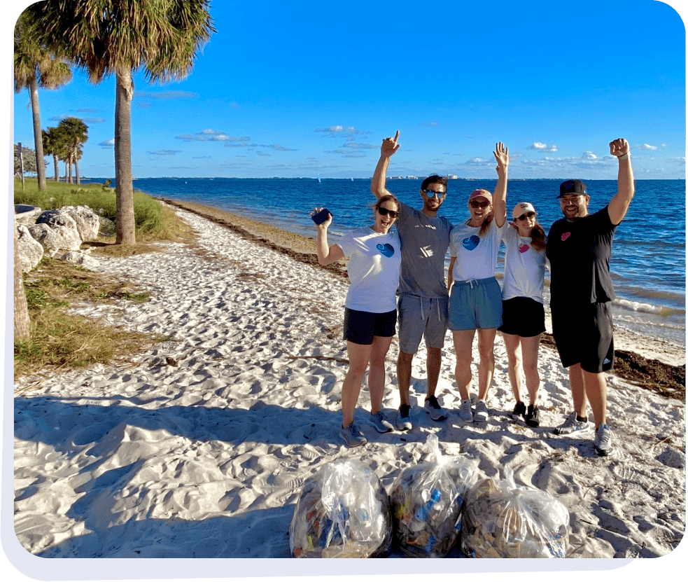 Spiral team posing on the beach