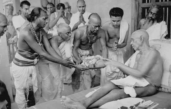 Ramana Maharshi seated with disciples, archival photograph