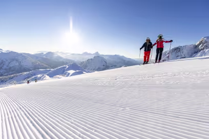 Twee skiers op een lege piste